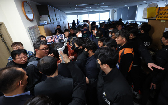 23일 경남 창원시 성산구 민주노총 경남본부 내 금속노조 경남지부에서 국가정원보원, 경찰이 압수수색을 시도하자 조합원이 항의하고 있다.  연합뉴스